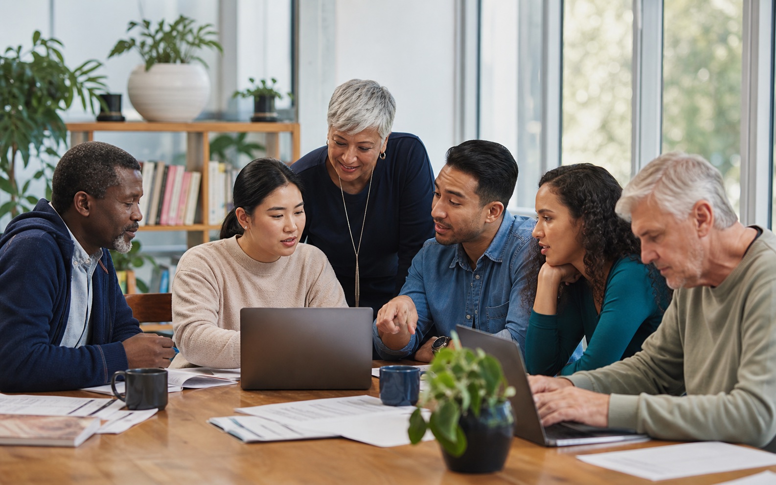 Adults from different generations learning together around a table